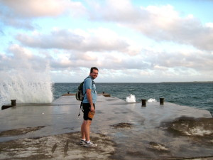 Waves crashing over the end of the dock at the beach. Patrick was getting brave.
