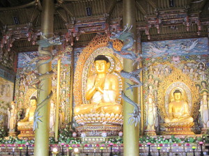 The centerpiece of the temple. The center statue is the largest Buddha in South Korea. Most people coming in took cushions to the front of the temple to lay prostrate in front of the Buddha. The side Buddhas were sitting in front of beautiful carved walls.