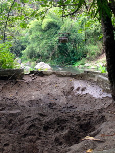 The fine volcanic sand from the river bed is collected and pulley-ed up to the village to make higher quality cement.