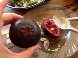 Mangosteen, or "honest fruit". The number of petals in "flower" on the bottom matches the number of fruit lobes inside!
